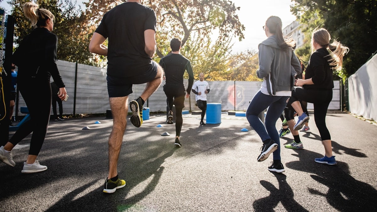 man in black t-shirt and black shorts running on road during daytime